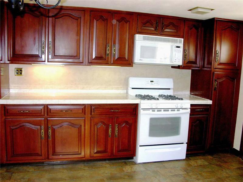 Natural wood cherry cabinets, eat in kitchen