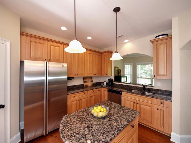 Chef's kitchen with island and granite countertops 