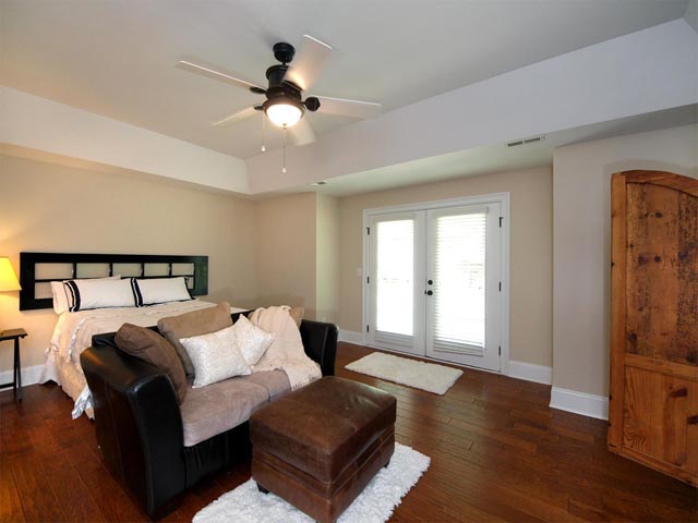 Main level master with tray ceiling and wood flooring