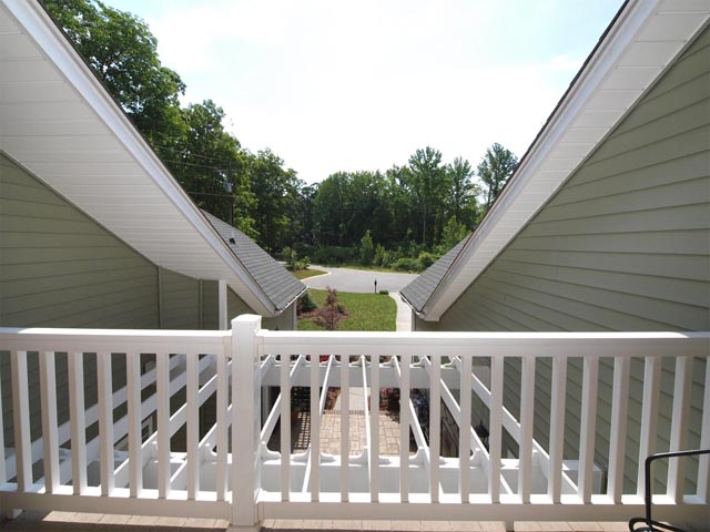 Upstairs balcony has view of wooded cul-de-sac