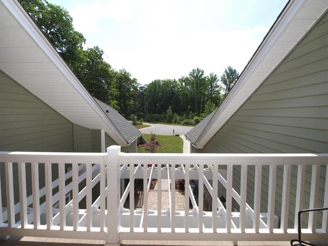 Upstairs balcony has view of wooded cul-de-sac