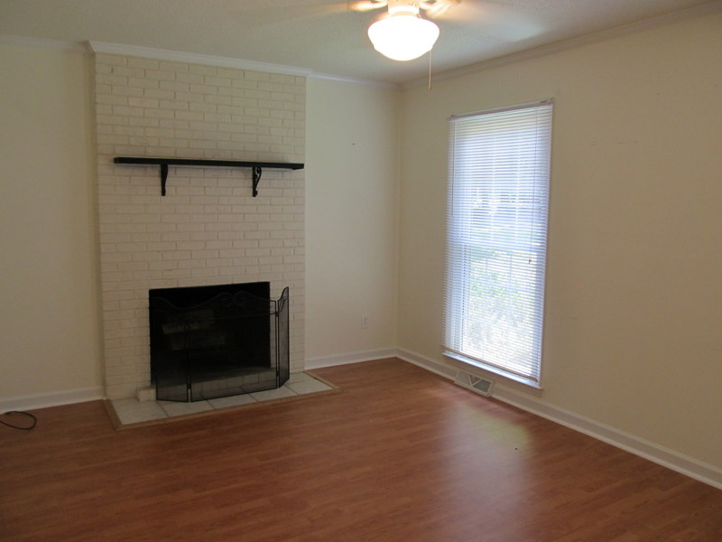 Den with masonry fireplace