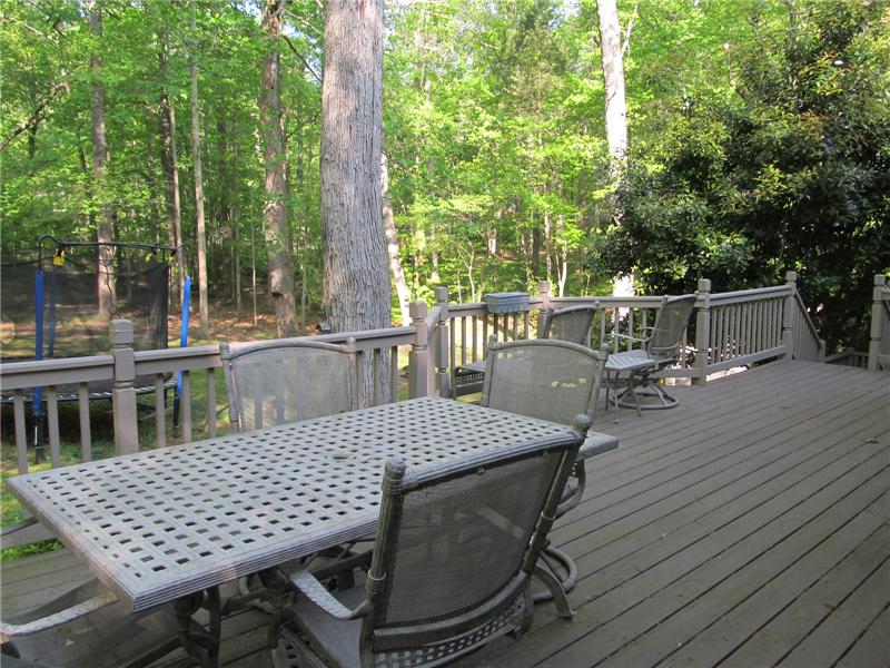 Long deck overlooks backyard