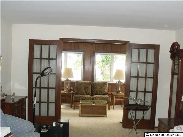 From the living room, french doors lead to large sun room.