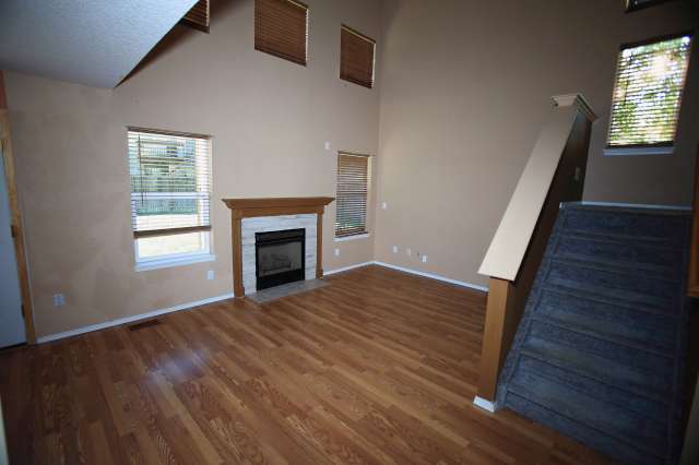 Living room with gas fireplace, Pergo flooring, and wired for surround sound