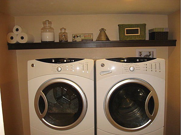 Laundry room with adjacent area for storage. Front loading washer, dryer, and laundry pedestals stay!!
