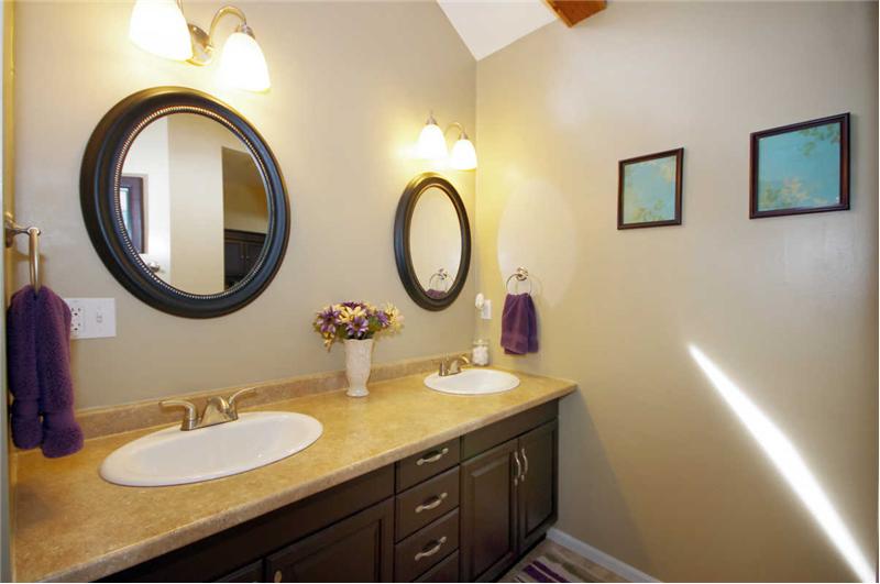 Master bathroom has his/her closets (with lighting), double sinks, a spacious tiled shower, and tile flooring.
