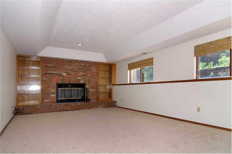 Spacious lower level family room with wood burning fireplace