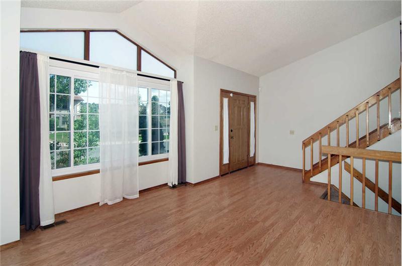 Nice sitting area with vaulted ceilings greets you as you enter the home
