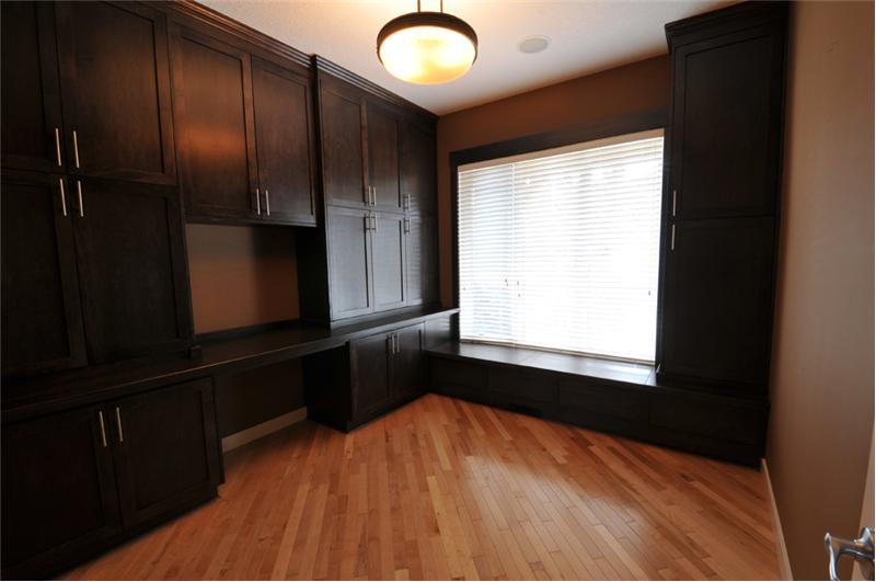 The den is just off of the front door and has built-in work station.