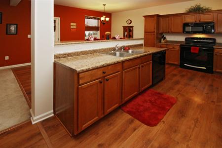 Kitchen with maple stained cabinets.