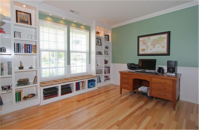Office/den has custom built in shelves & window seat.