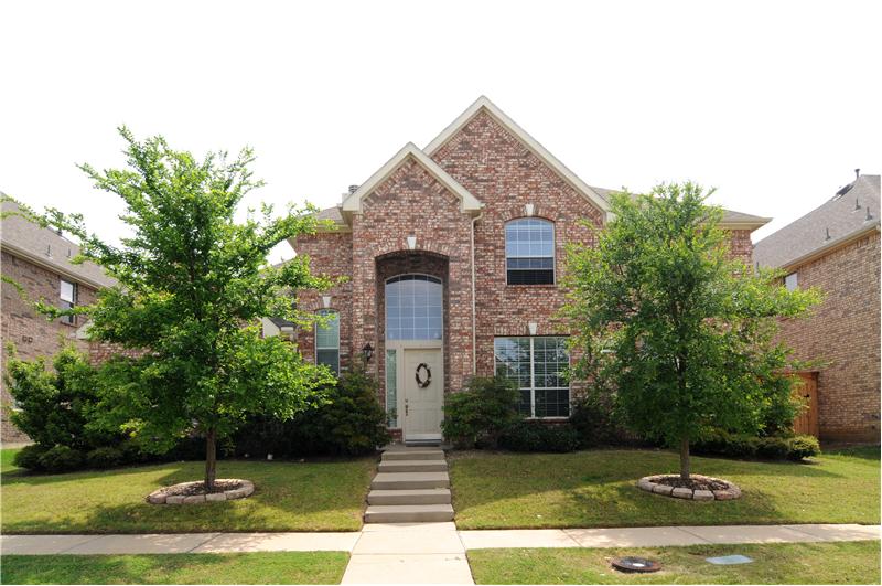 Beautiful curb appeal in this exclusive gold course community!