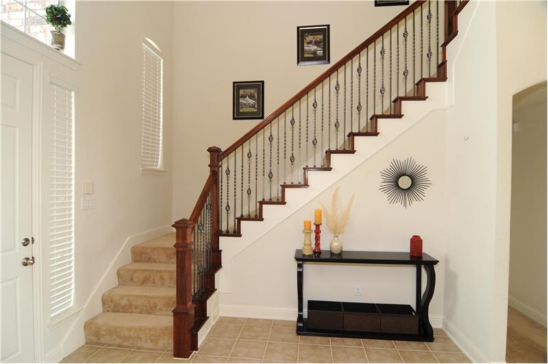 The stairs lead up to 3 bedrooms, a full bath, and a game room.
