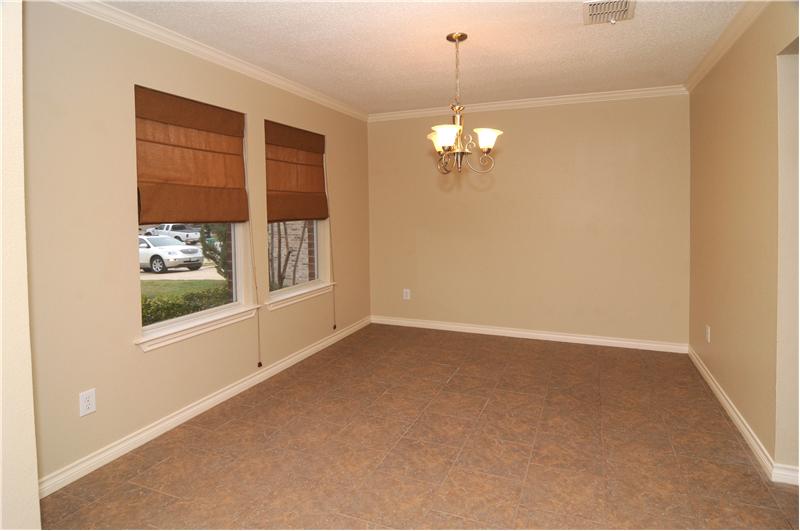 Take note of the window treatments and decorative lighting in the dining room.