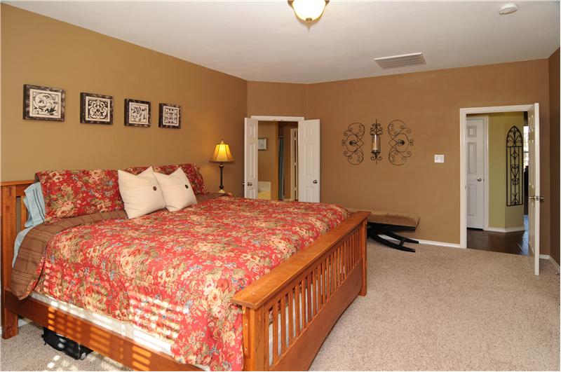 The master bedroom is downstairs and offers nice views of the pool.