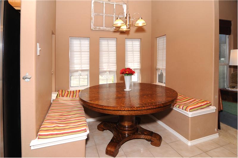 The cozy breakfast nook is just off the kitchen and has decorative lighting.