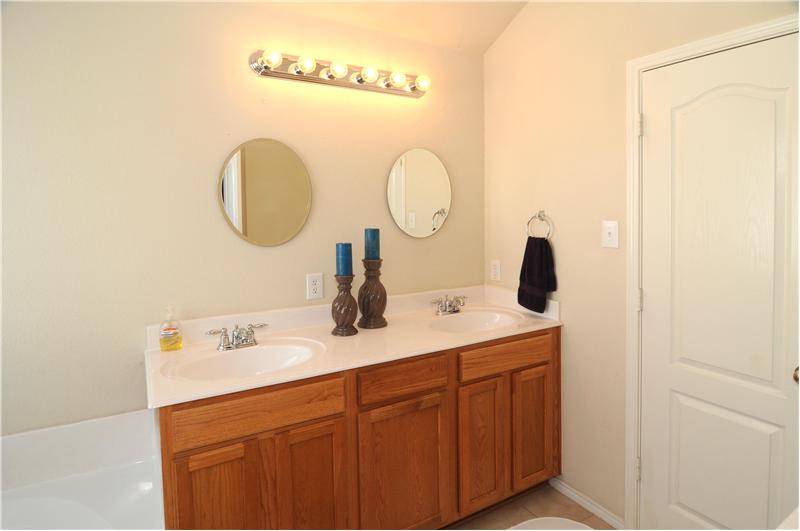 With modern mirrors and lighting the master bath will surely impress.