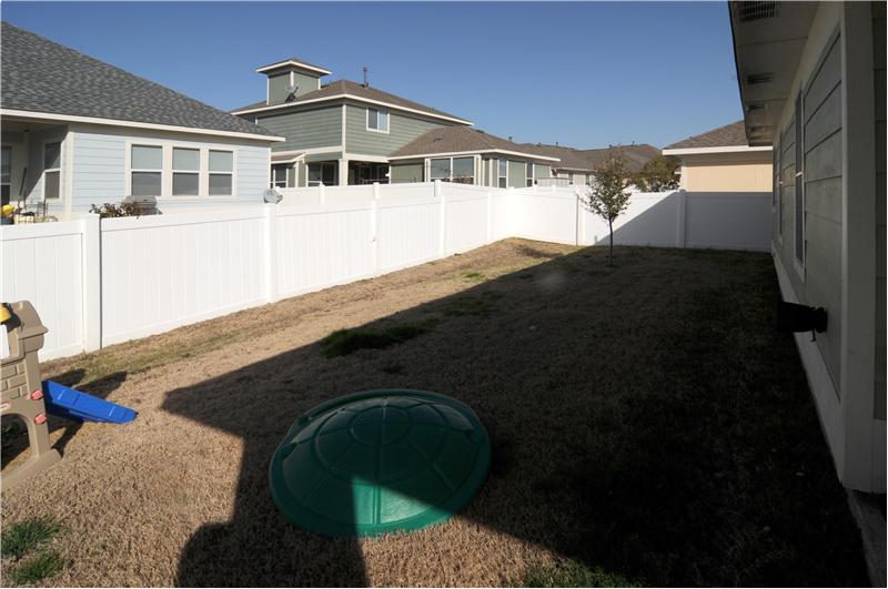 The home has a fenced backyard.