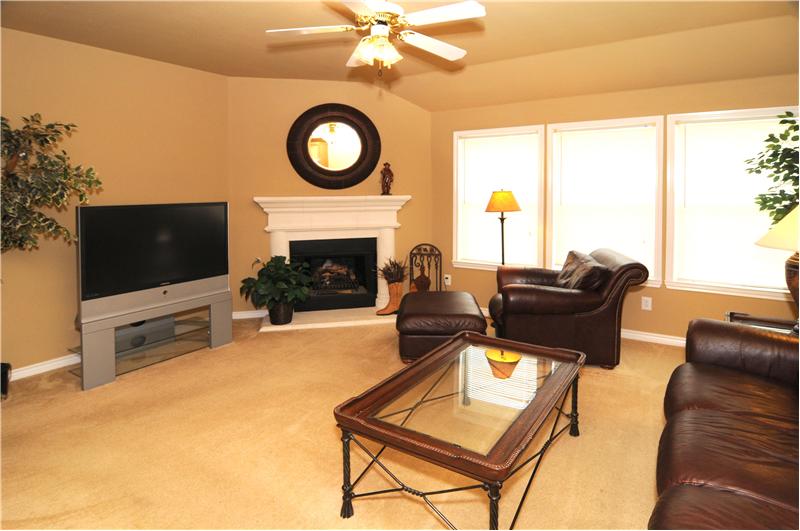 Natural light and ceiling fan are features of this living space