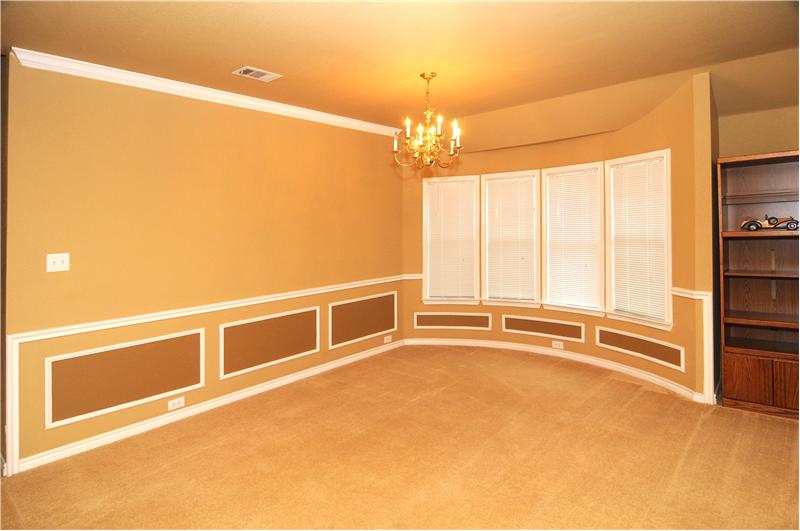 Decorative lighting can be found in the formal dining room