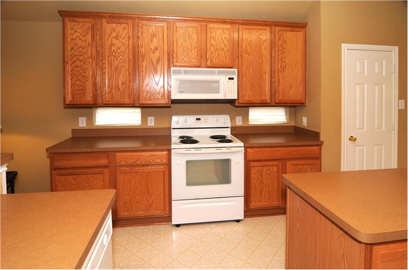 Enjoy cooking in the kitchen while looking onto the activity in the living room