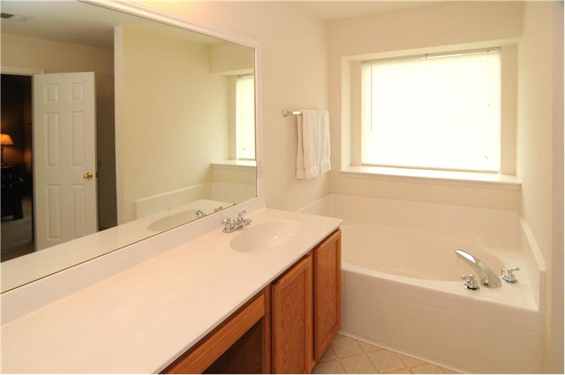 Separate vanities and a separate shower are features of the master bath