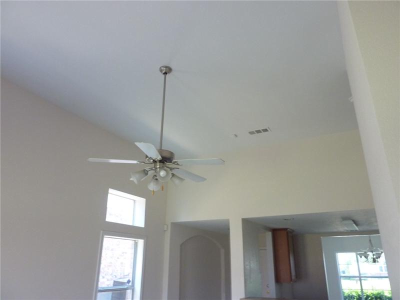 High ceilings with ceiling fan in the living room.