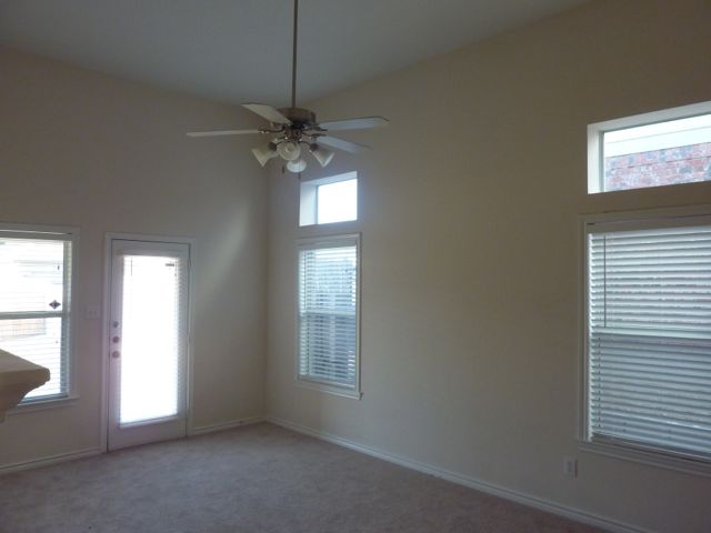 The home offers high ceilings, ceiling fans, and beautiful natural light!