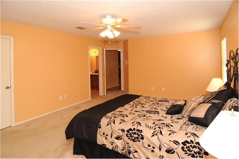 Spacious master bedroom has a large walk-in closet attached.