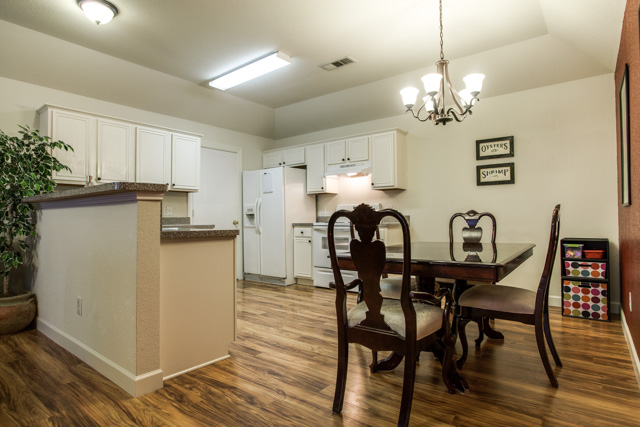 The open floor plan takes you to the eat-in kitchen.