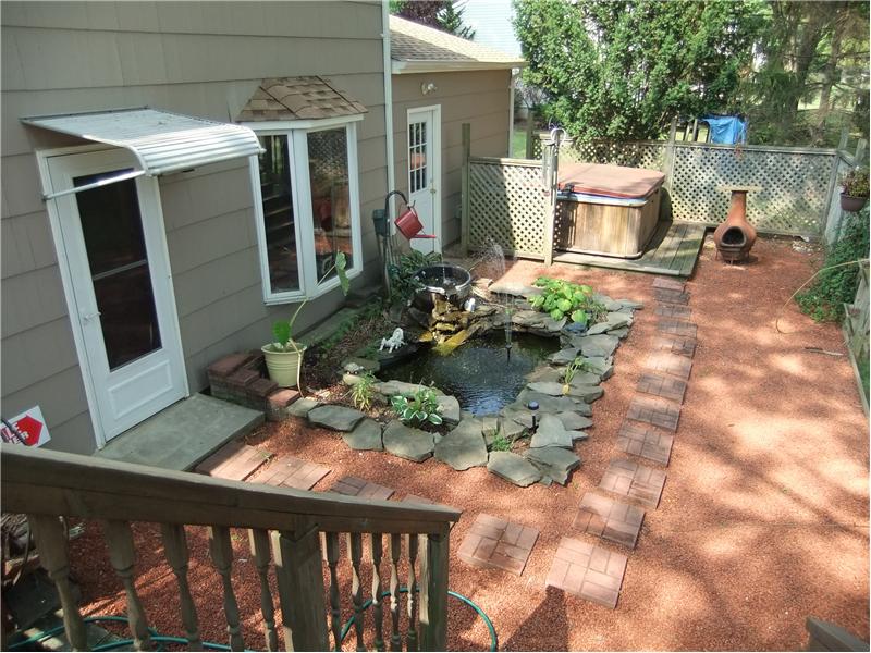 Deck to patio with koi pond