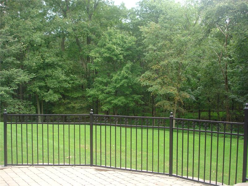 Patio overlooks preserved woods