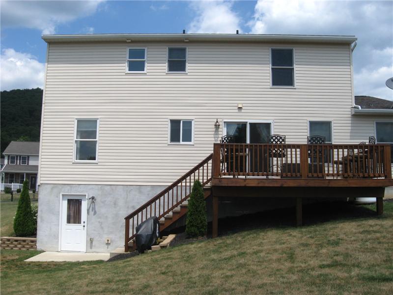 Back of the house with a walk-out basement and a deck for relaxing.