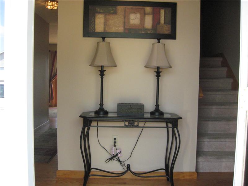 Welcoming foyer with hardwood floors.