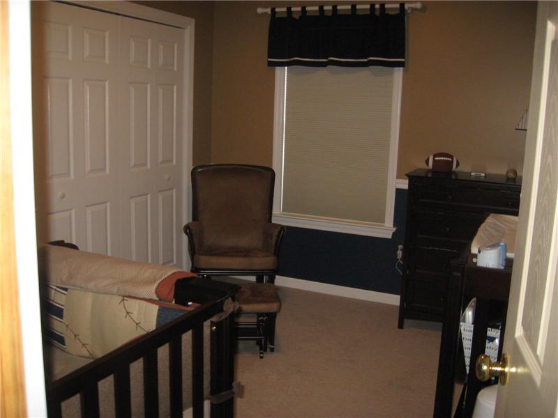 Bedroom with carpeting.,