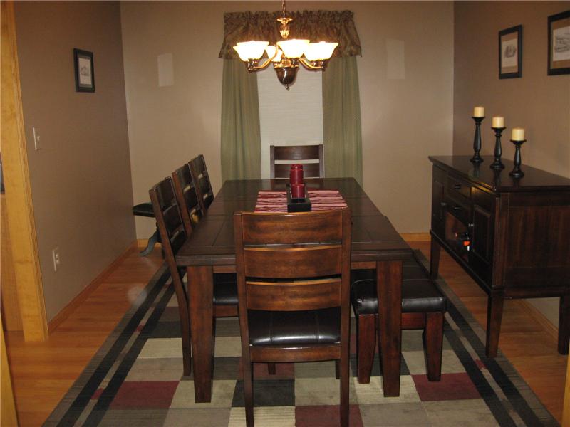 Spacious dining room with hardwood flooring.