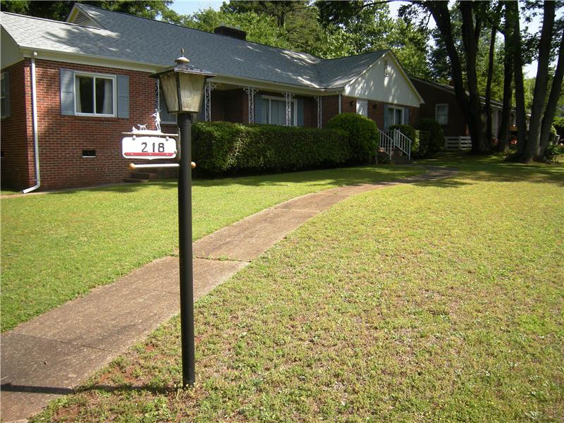Level lot with sidewalk has mature growth & curb appeal