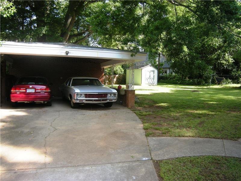 Two car carport with a huge utility room containing the laundry room
