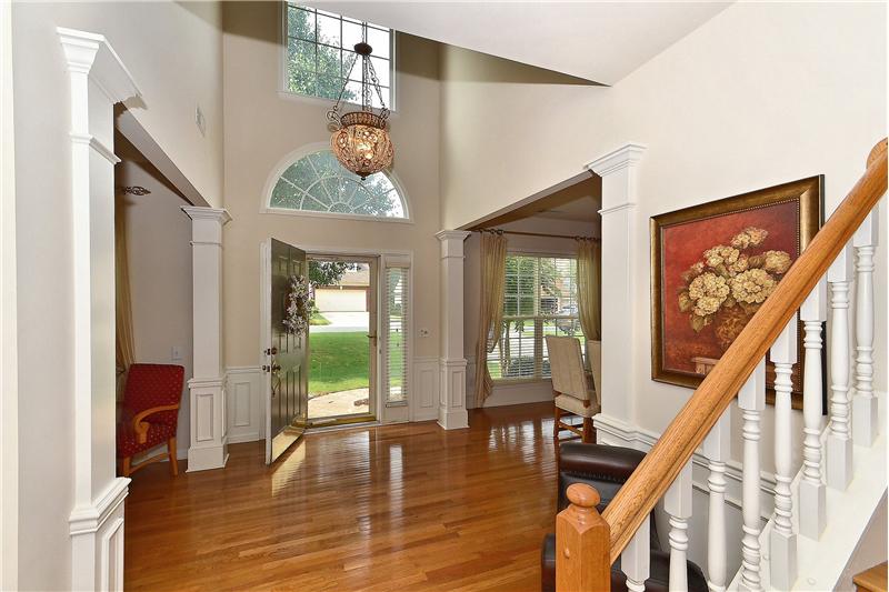 Impressive two story foyer accented by the exquisite chandelier