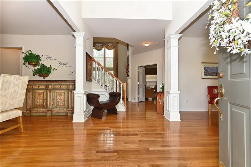 Beautiful hardwood floors & extensive crown moldings greet you as you enter the home