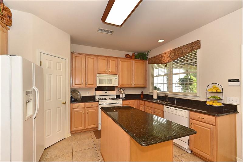 All white appliances, gas range/oven and large granite island