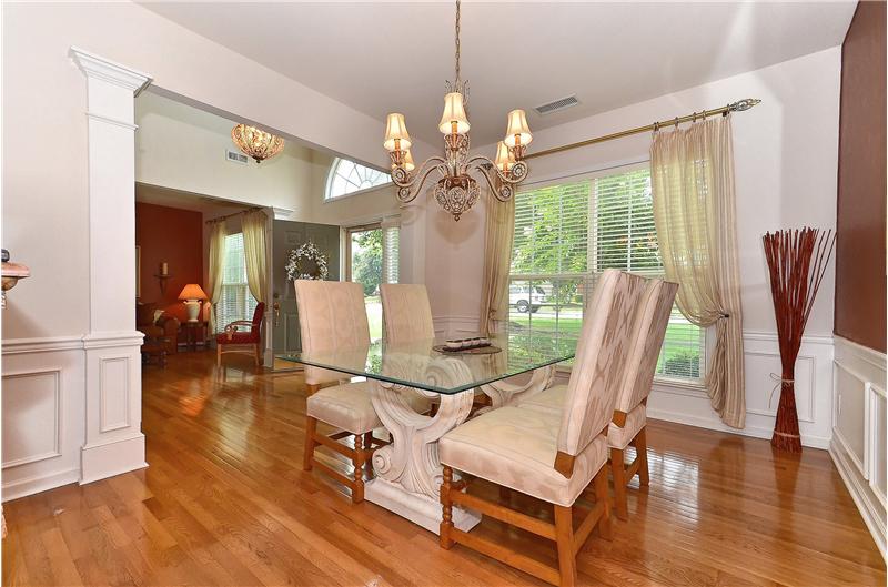 Beautifully appointed dining room with custom moldings and high-end lighting