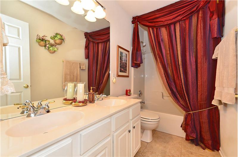 Second full bathroom has dual vanities, tub/shower combo and beautiful cabinetry