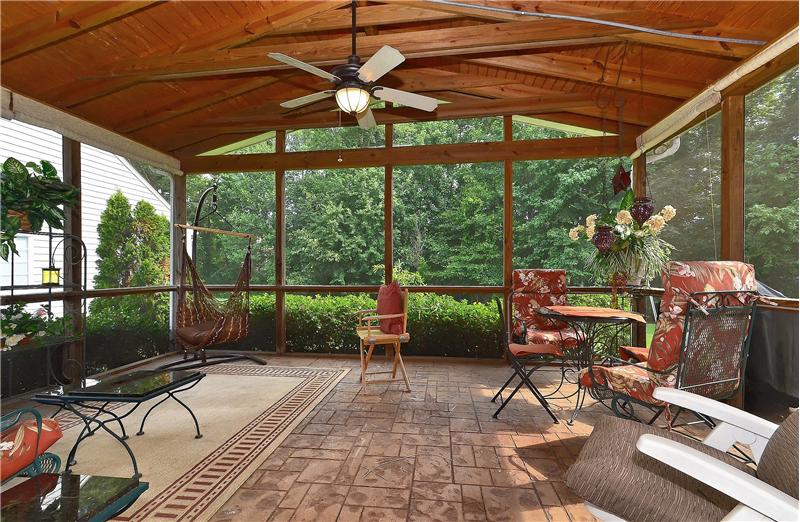 Spacious, awe inspiring screened in porch has beautiful paver flooring