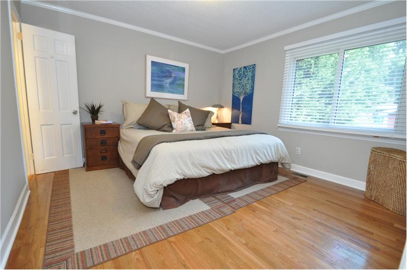 Spacious master bedroom has hardwoods and neutral paint