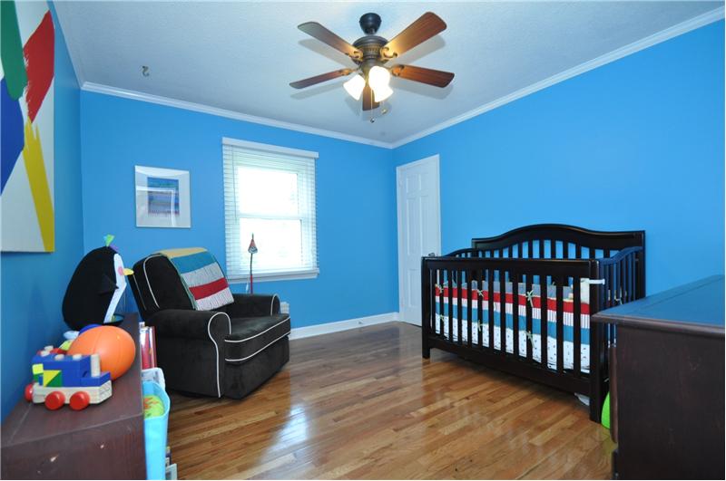 Third bedroom is spacious with hardwoods, custom paint & ceiling fan