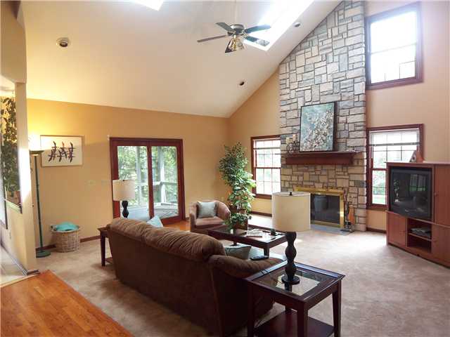 Family Room:  Sun-filled large family room with heart warming floor to ceiling stone mantle log burning fireplace