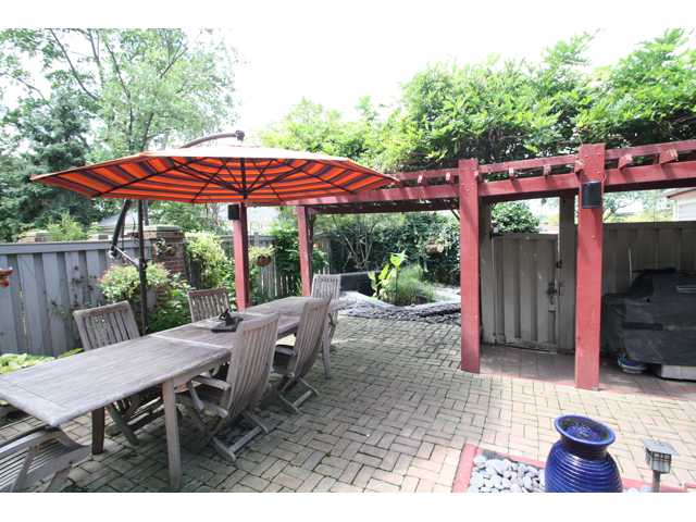  Expansive paver patio with water features, lush landscape