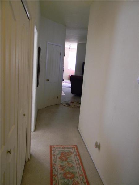 Wide hallway and inside laundry behind the closet doors to the left